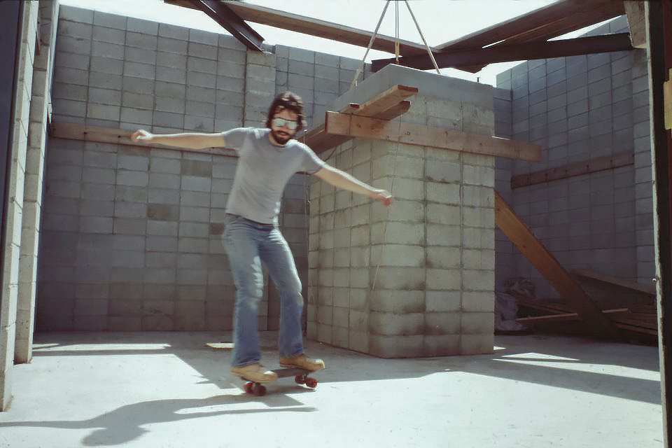 John Asztalos skateboarding on the newly poured floor.